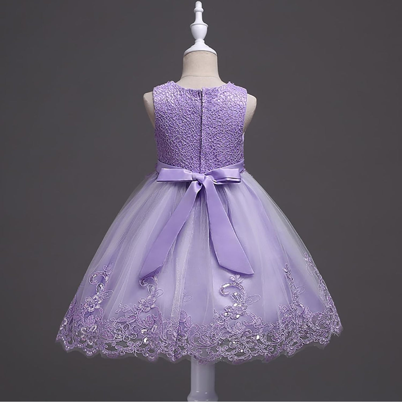 DreamHigh Flower Girl Dress for 3-10 Years Old Girls by AURORE LUXURE, worn by a girl smiling in a lovely purple embroidered dress showcasing pearl embellishments.