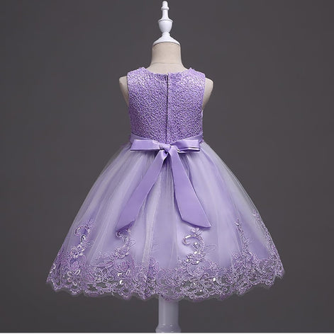 DreamHigh Flower Girl Dress for 3-10 Years Old Girls by AURORE LUXURE, worn by a girl smiling in a lovely purple embroidered dress showcasing pearl embellishments.