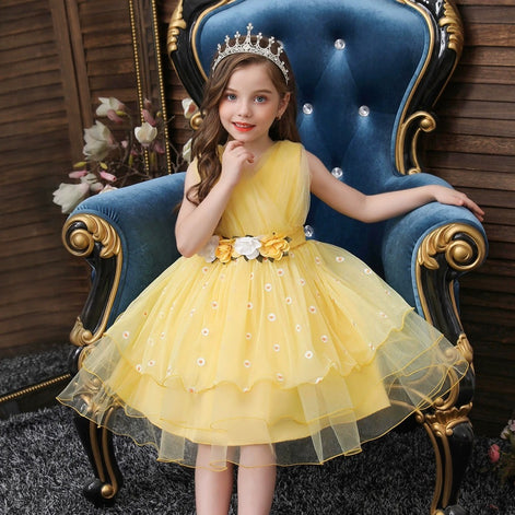 Cute girl wearing a yellow dress with floral embroidery, part of the Baby Girls Dresses Summer collection.