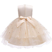 Back view of a cream dress with a stylish bow, designed for the Baby Girls Dresses Summer line.