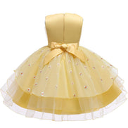 Profile view of a girl in a beautiful yellow dress, featured in the Baby Girls Dresses Summer collection.