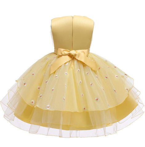 Profile view of a girl in a beautiful yellow dress, featured in the Baby Girls Dresses Summer collection.