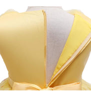 Girl smiling in a yellow dress with flowers, included in the Baby Girls Dresses Summer collection.